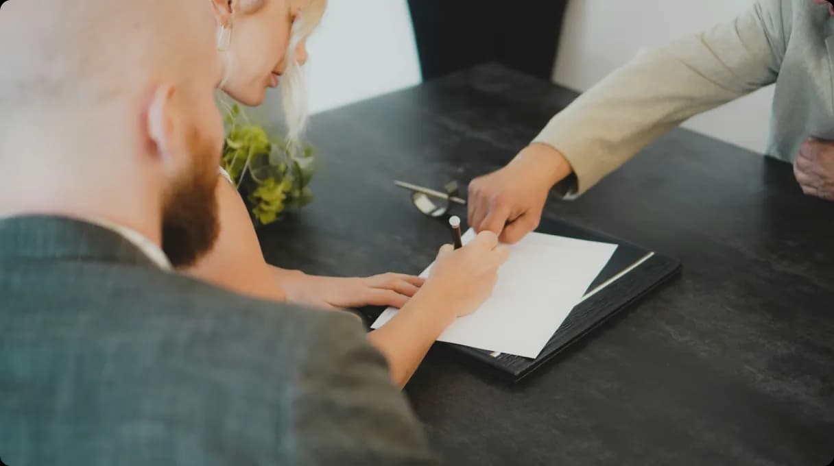 A woman showing a man something on a tablet