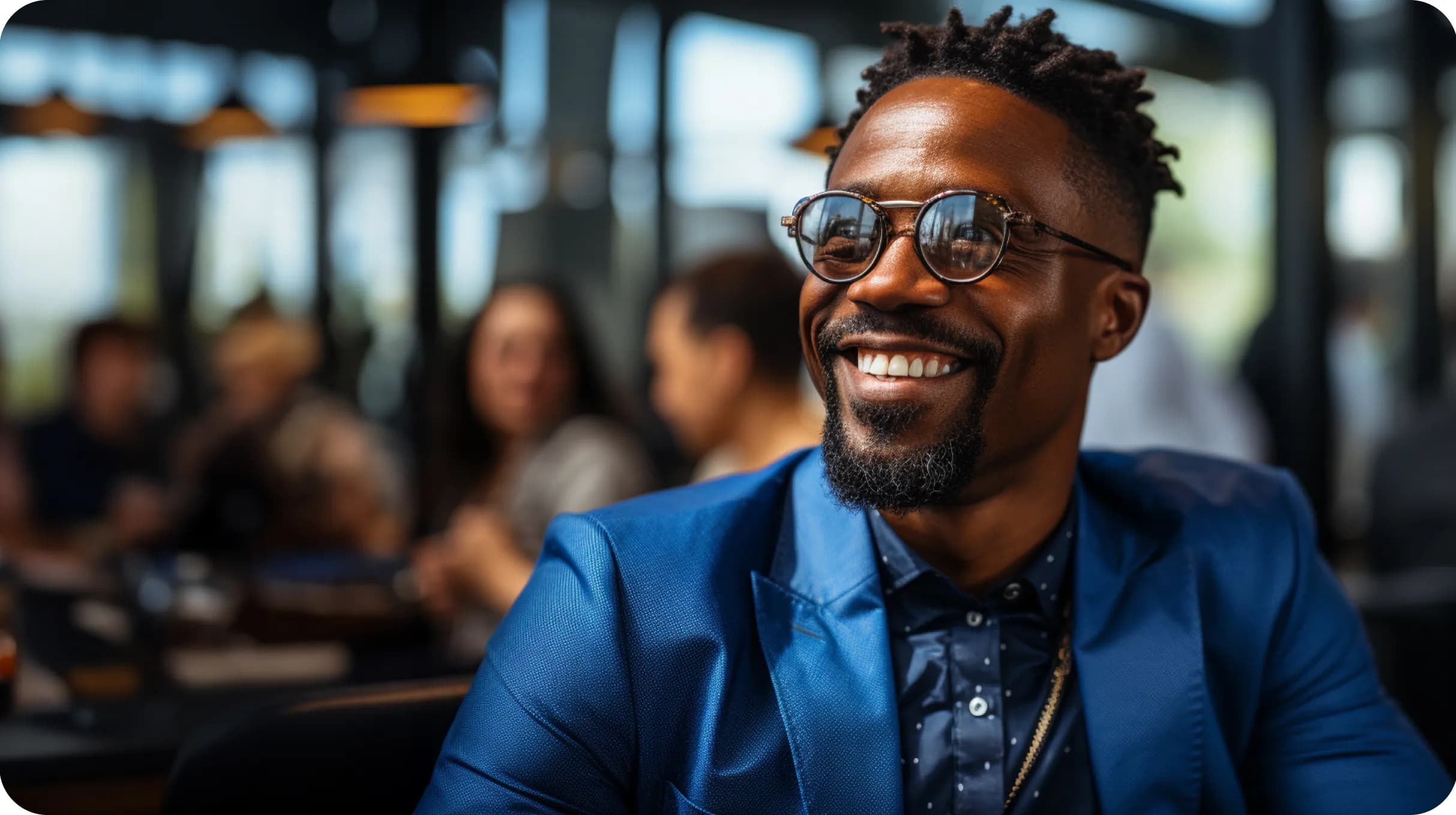 Stylish man in a navy blue elegant suit in a busy place with people blurred in a background