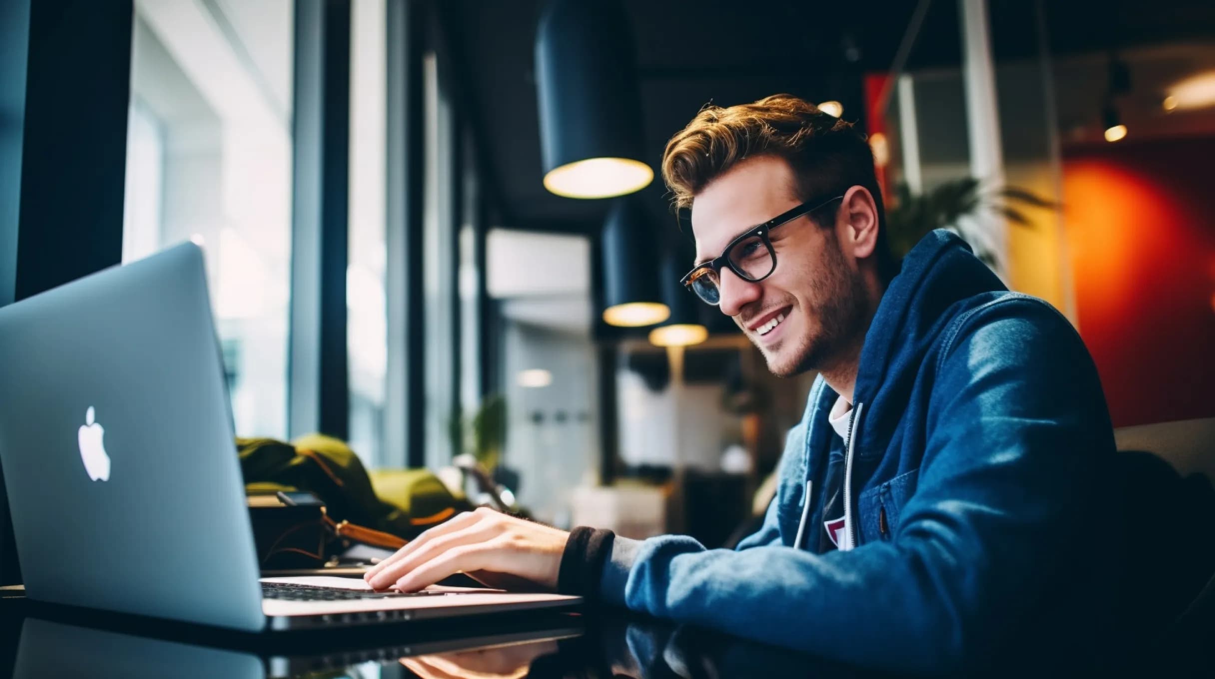 A man working on a Macbook in a restuarant