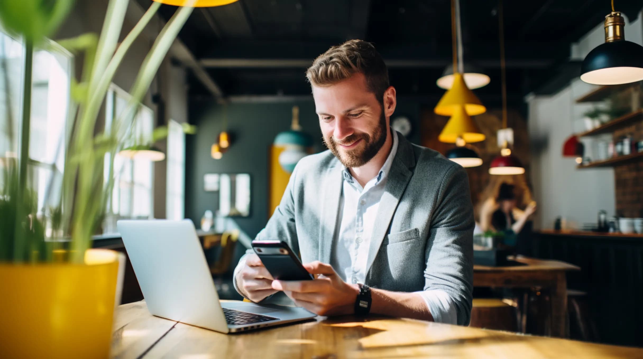 Entrepreneur sitting in an office with laptop and smartphone