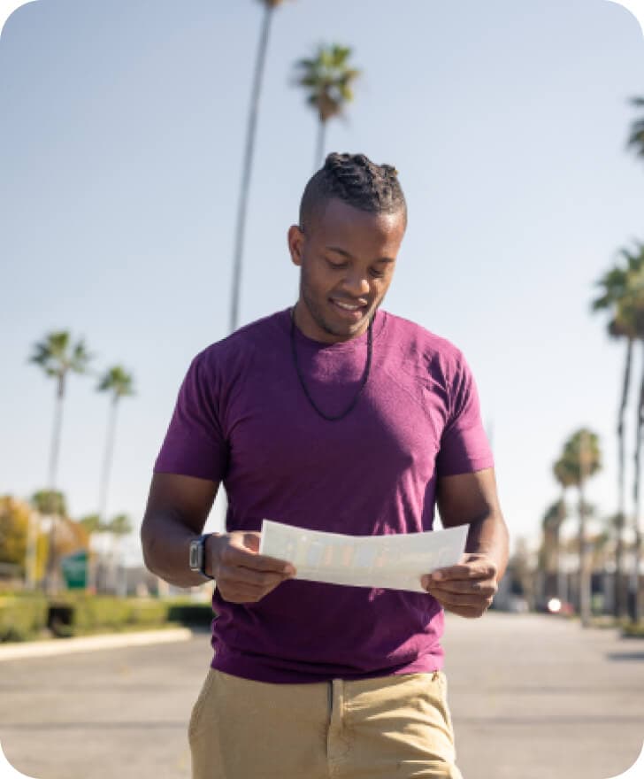 Danilo Batson holding a document and smiling