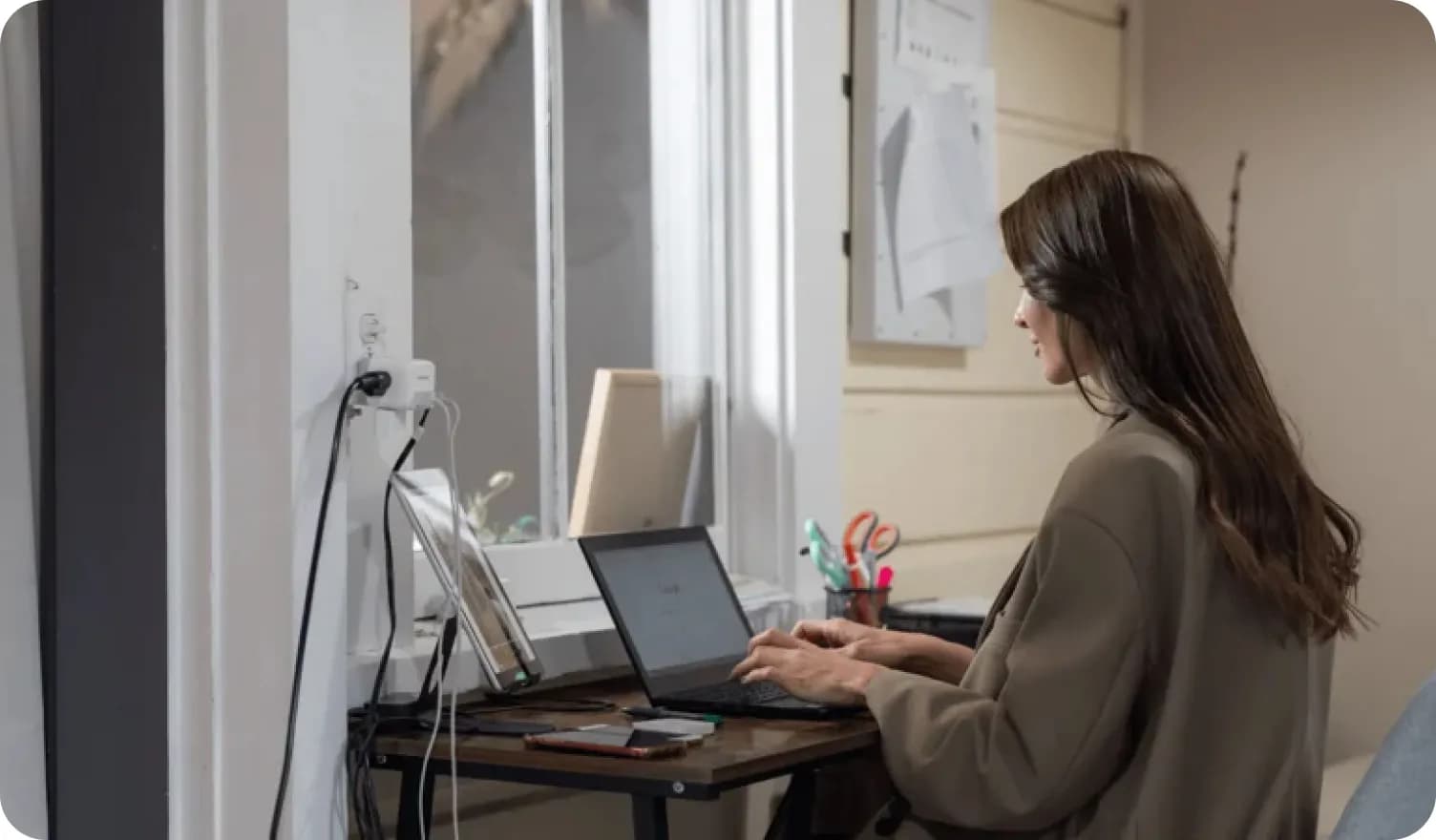 Marina Andriichenko sitting at the desk and writing on the computer