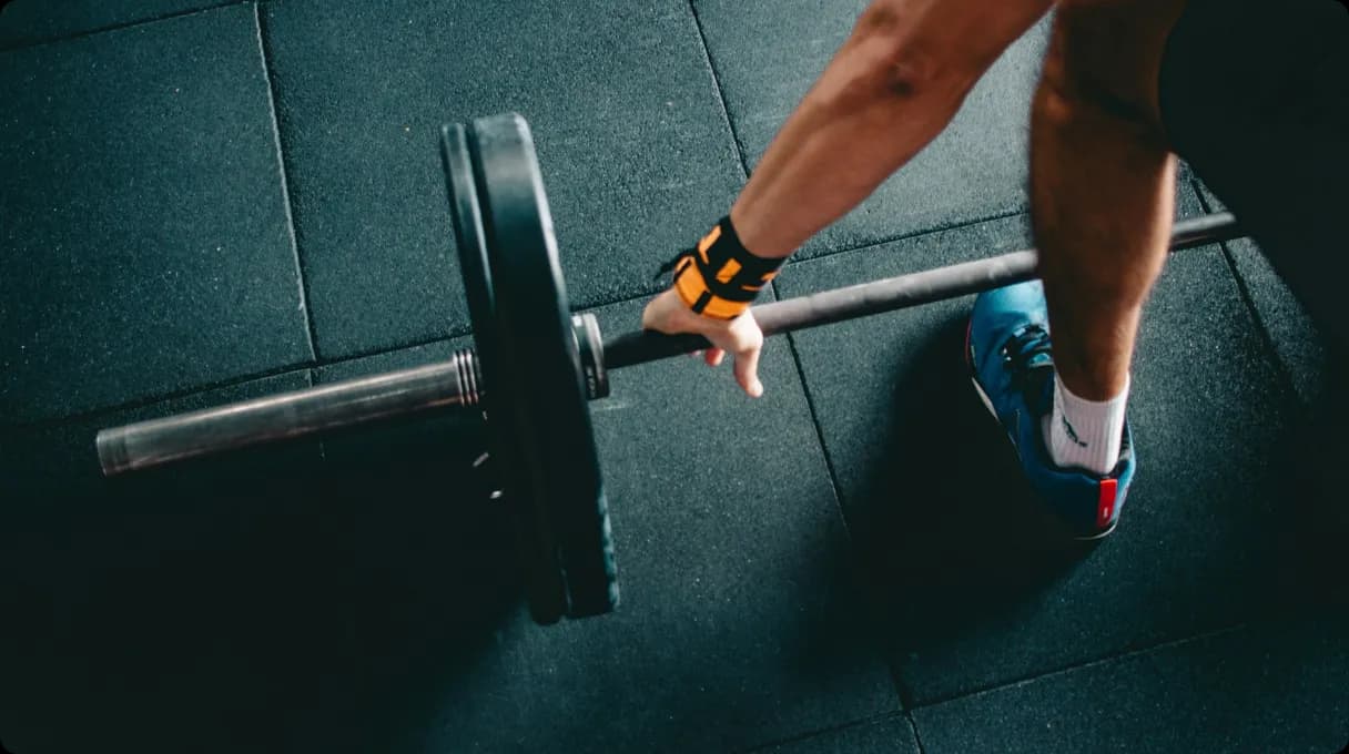 man-holding-black-barbell