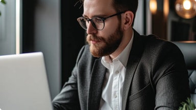 man-in-a-suit-using-a-macbook