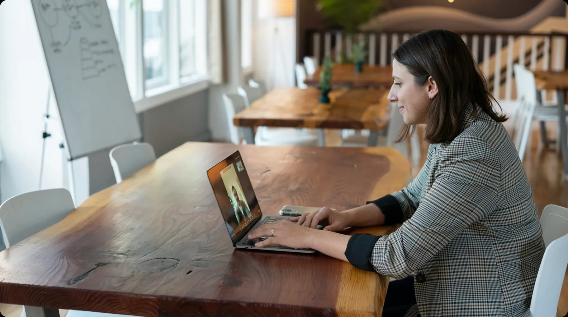 woman-in-gray-and-white-striped-long-sleeve-shirt-using-silver-macbook