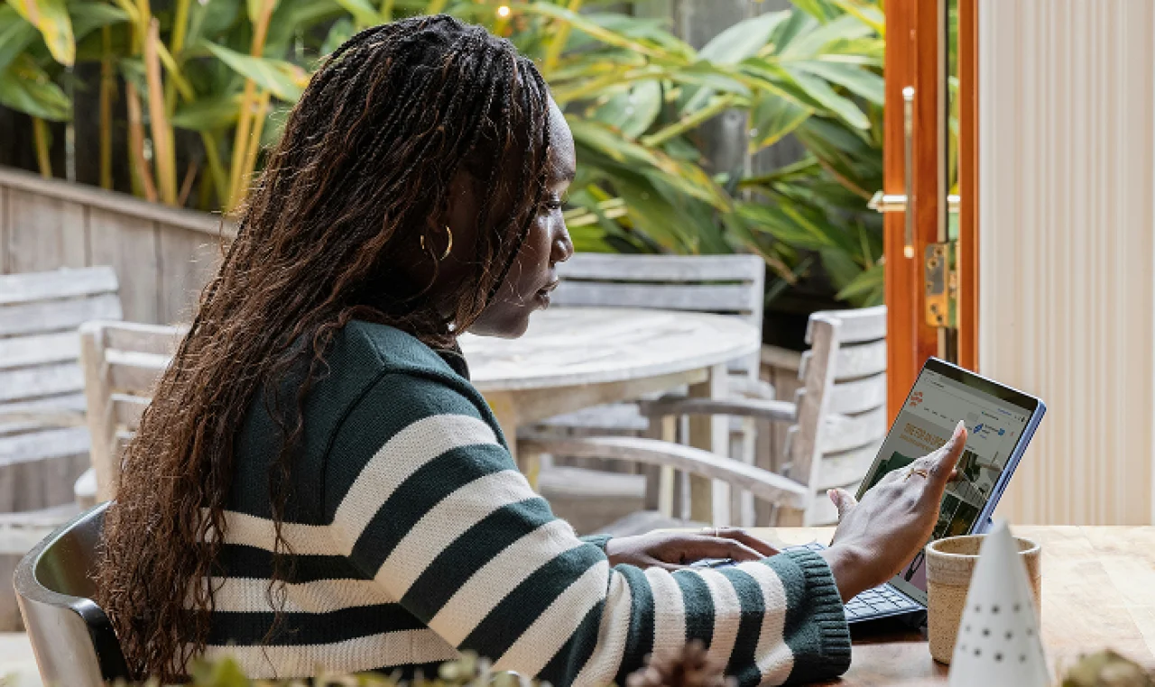 Solo entrepreneur managing business compliance from home using low-cost tools, reviewing legal structure options, registering a business name, organizing tax info, and tracking deadlines with a digital calendar