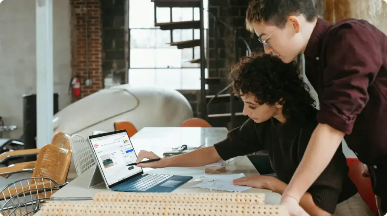 Young people working with a laptop.